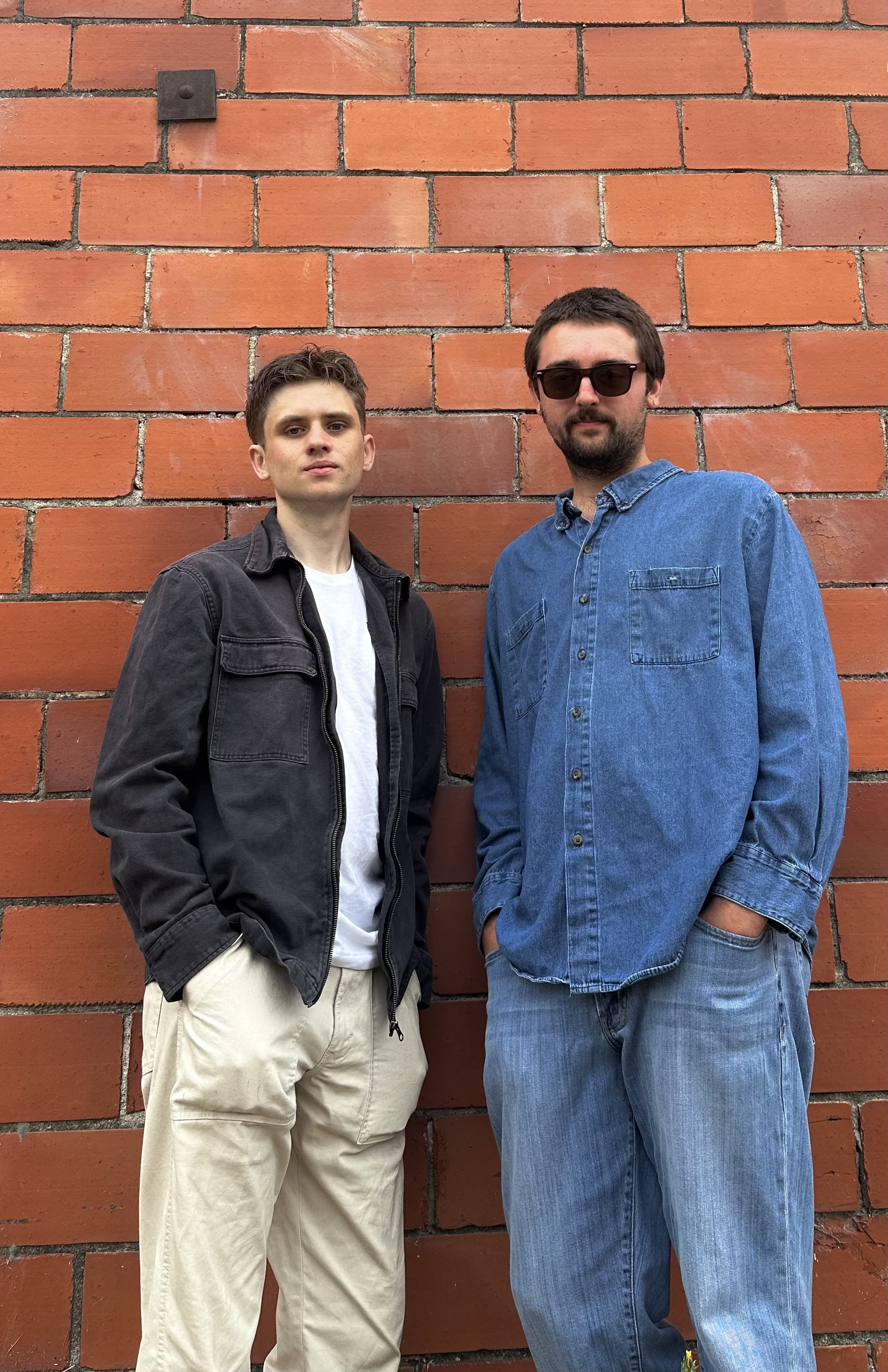 Northern Disconnection performing in front of a brick backdrop